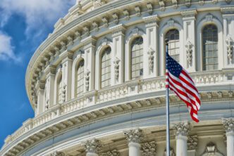 Washington DC Capitol building detail with a waving American flag