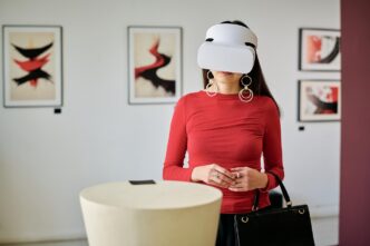 A woman wearing a VR headset interacts with virtual art displayed in a gallery setting.