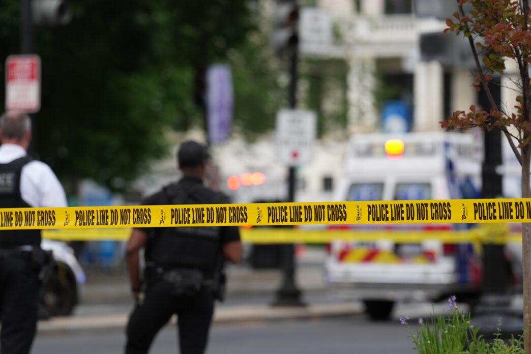Chicago police officers investigate an armed robbery scene.