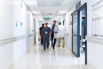 Diverse medical staff walking in a busy hospital corridor