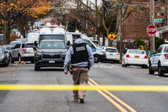 Federal agent standing at a crime scene regarding FBI ICE shooting.