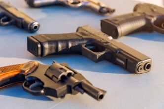 Various handguns displayed on a surface, linked to Gagarin Iurii based on the filename.