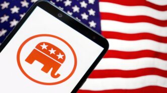 Smartphone displaying Republican Party logo with American flag in the background.