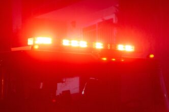 Fire engine with flashing red lights responding to arson investigation