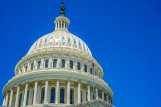 Low angle view of the US Capitol building against a blue sky