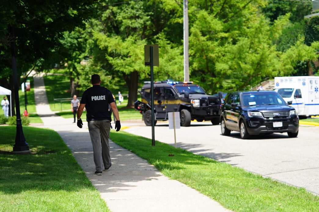 Trooper police and federal officers engaged in a tactical standoff operation.