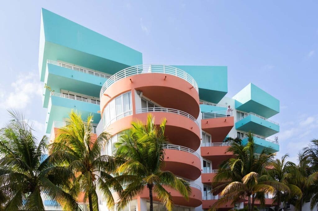 An impressive Art Deco building in pastel blue and pink papaya hues located in Miami Beach.