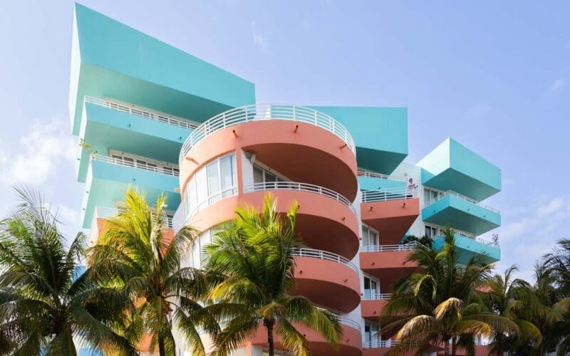 An impressive Art Deco building in pastel blue and pink papaya hues located in Miami Beach.