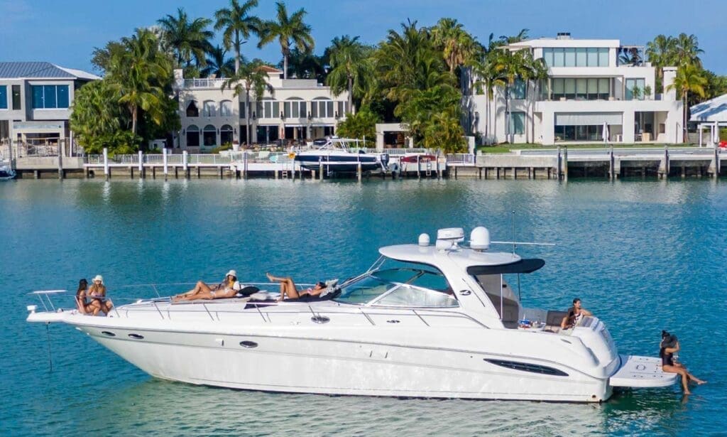 Miami Travel: Girls enjoying the sun and sea near luxury houses in Miami Beach.