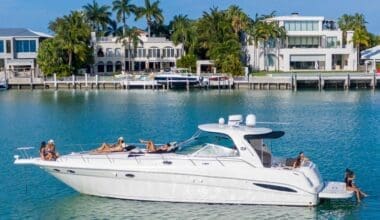 Miami Travel: Girls enjoying the sun and sea near luxury houses in Miami Beach.