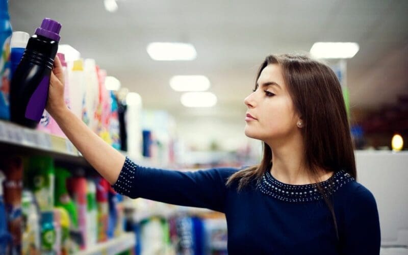 Woman choosing detergent in the supermarket