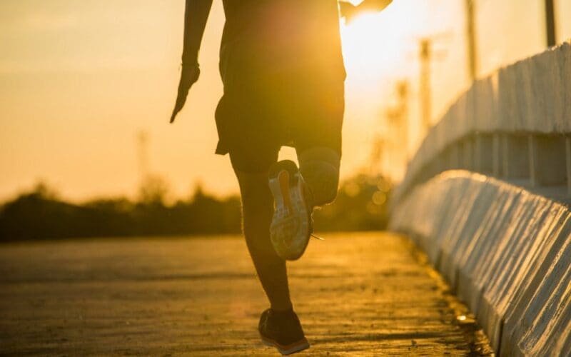 Runner at dawn on a causeway