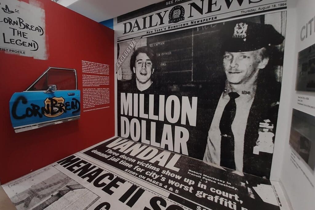 A historic newspaper wall stretching from ceiling to floor at the Museum of Graffiti.