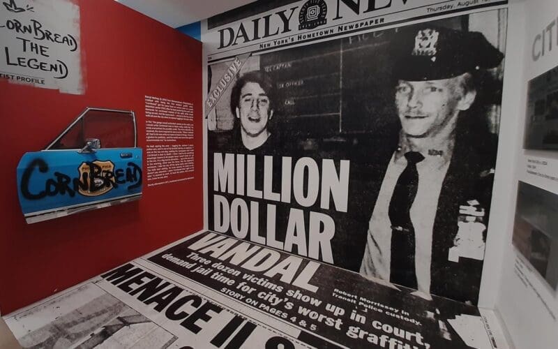 A historic newspaper wall stretching from ceiling to floor at the Museum of Graffiti.