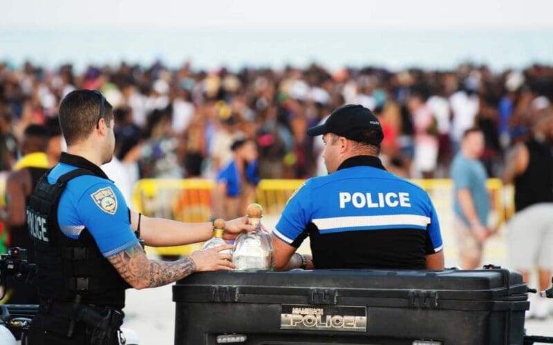 Police officers monitor crowd gathering at South Beach for annual spring break