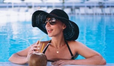 Woman in a Miami Beach hotel pool drinking a coconut cocktail